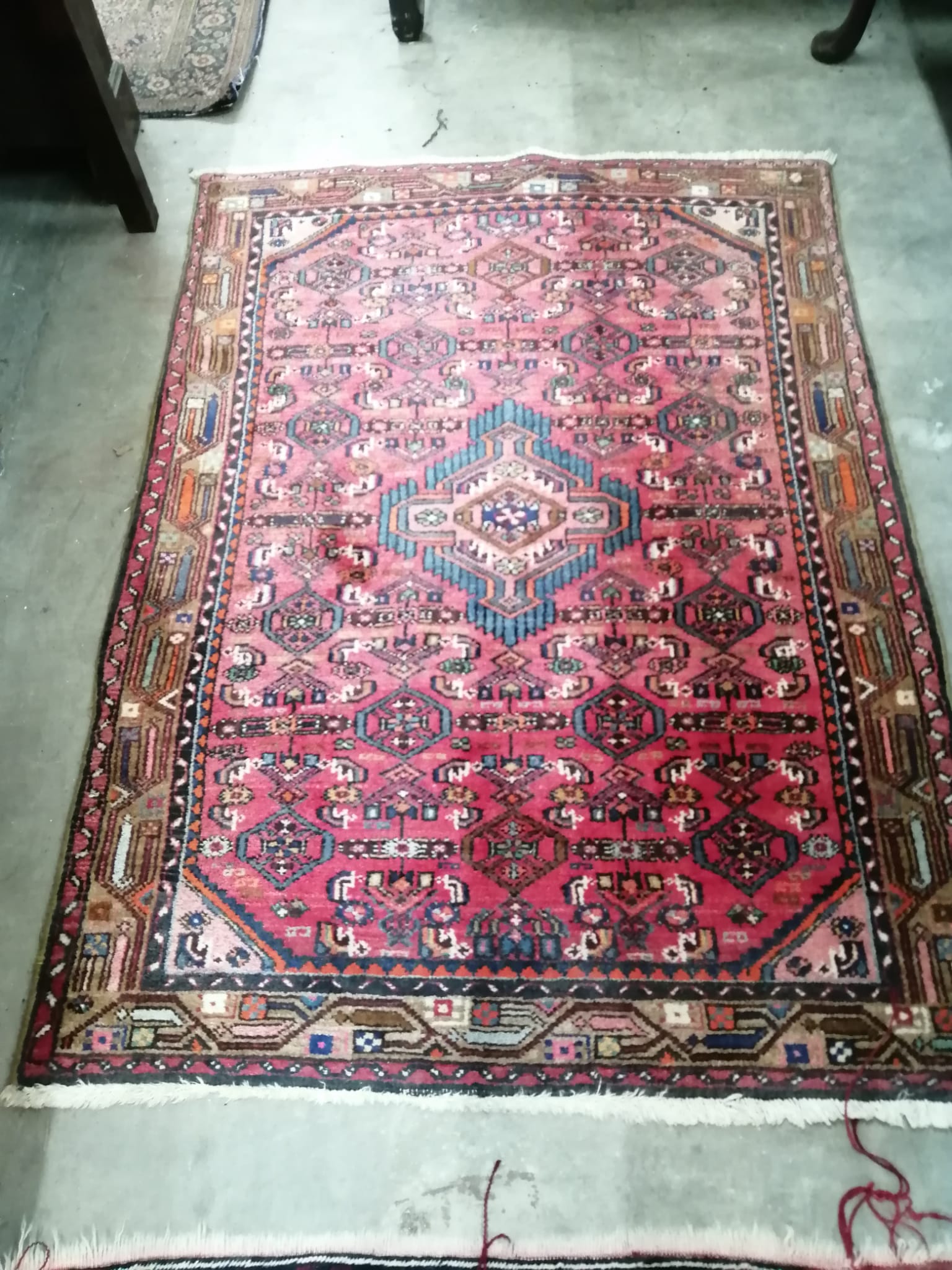 A Caucasian style burgundy ground rug and a North West Persian red ground rug, larger 194 x 106cm